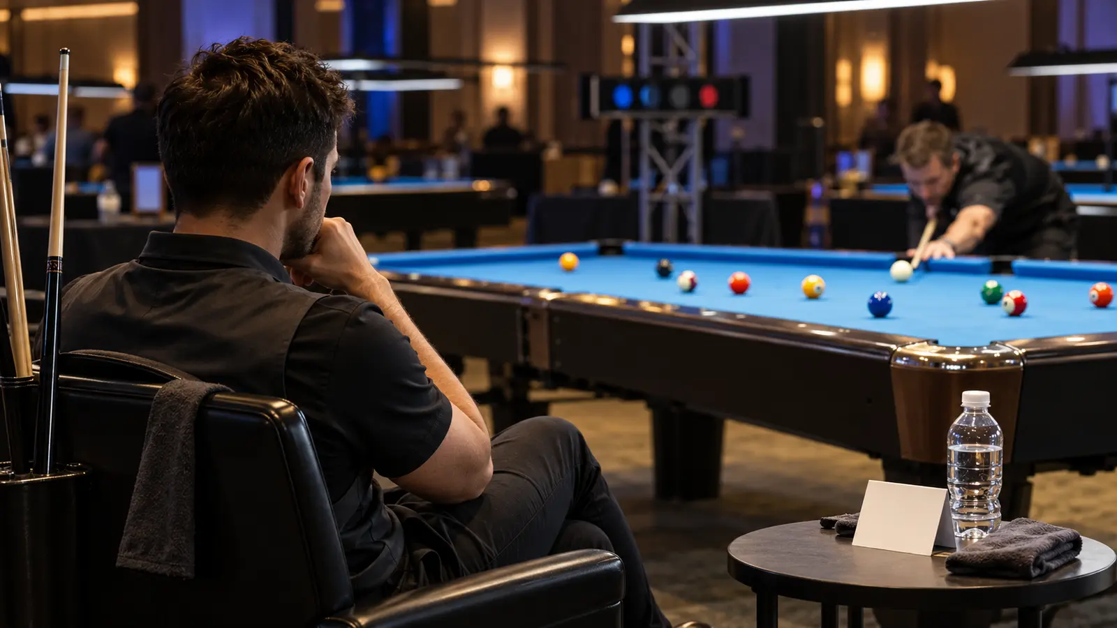 Focused pool competitor observing the table between turns during a structured match