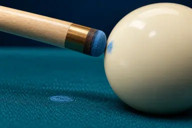 Generic macro illustration of a chalked cue tip, a blue mark on a cue ball and loose chalk dust on pool cloth
