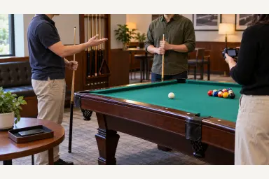 Phone face down in a tray away from a pool table while players agree before a camera is used