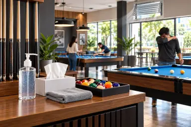 AI illustration of a bright billiards room with sanitizer, tissues, a cleaning cloth and shared pool equipment