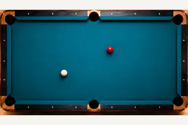 One white cue ball and one red object ball resting separately on pool cloth without trajectory marks