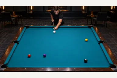 Pool player assessing a quiet table with stationary balls and no trajectory overlays
